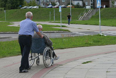 pushing elder on wheelchair